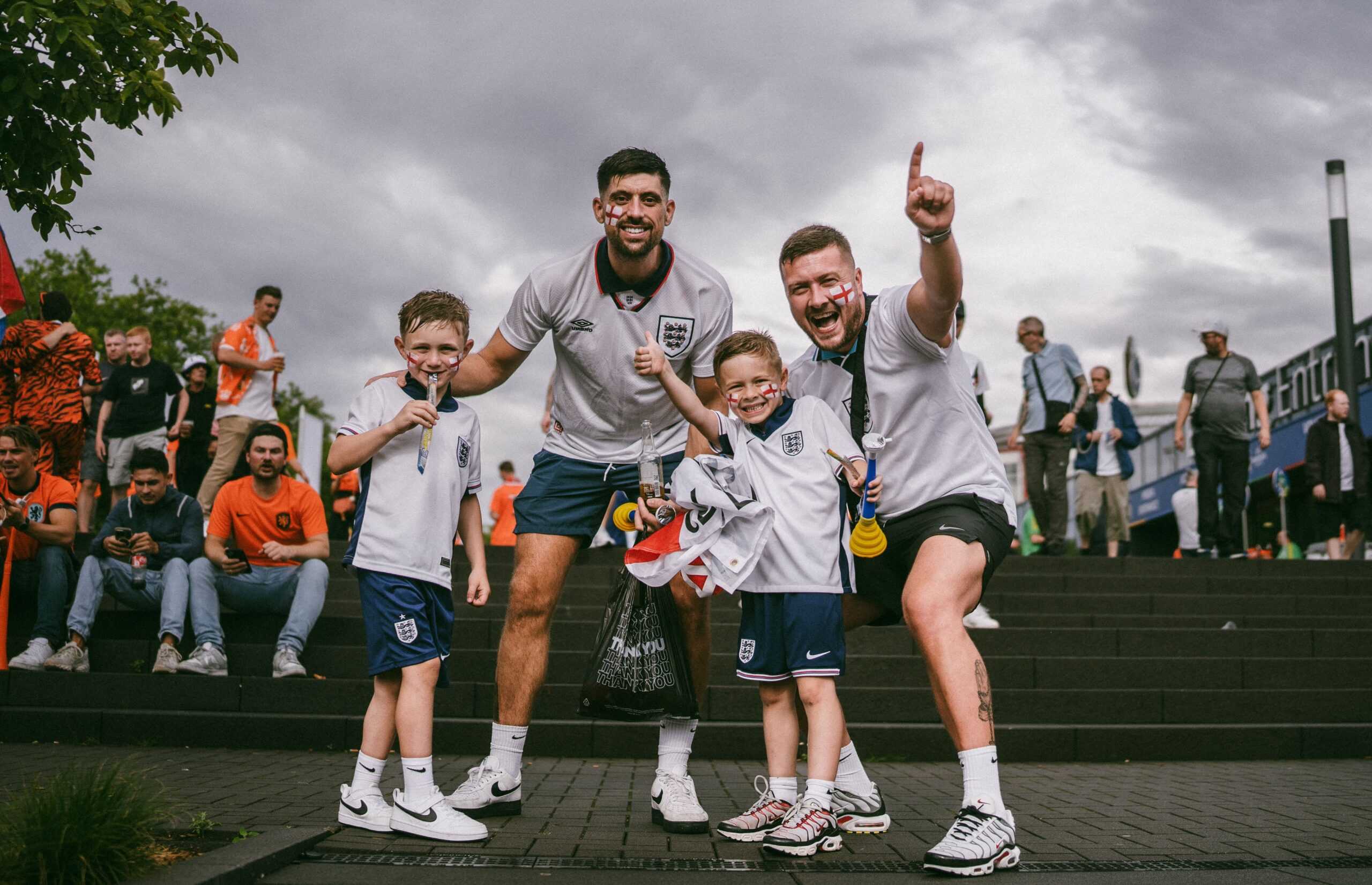 A professional sports photograph capturing Jude Bellingham in his England jersey celebrating with a fist pump after scoring against Mexico