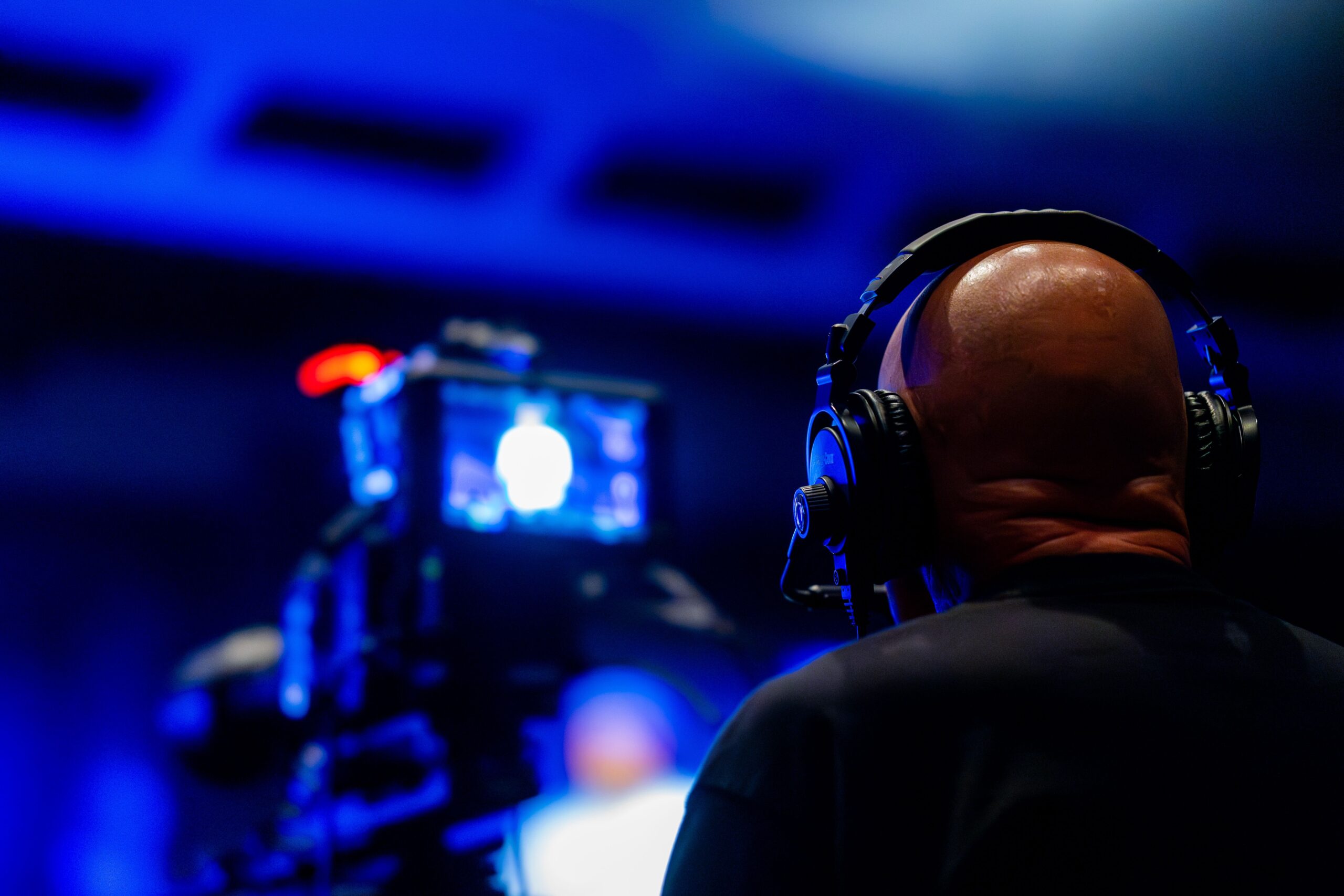 A high-quality media journalism photograph showcasing glowing neon studio lighting setups inside a contemporary entertainment production facility