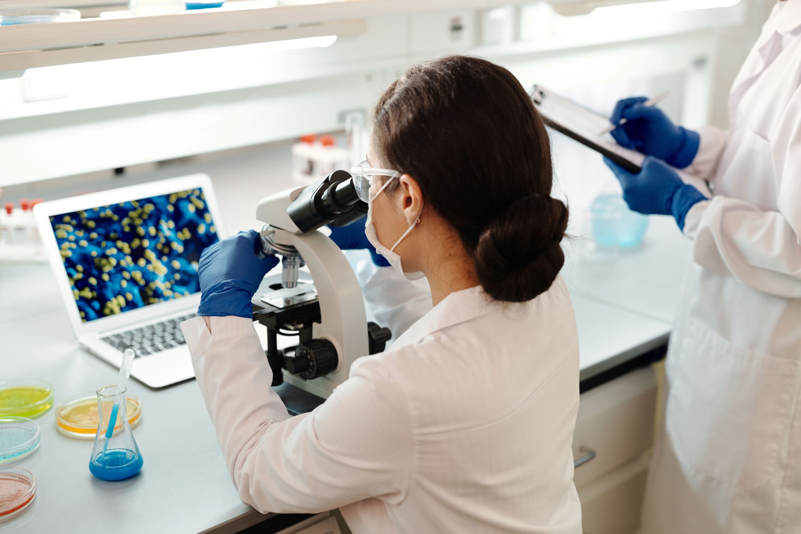 A high-end laboratory environment featuring modern clinical diagnostic equipment and microscopic analysis indicators reflecting advanced medical research