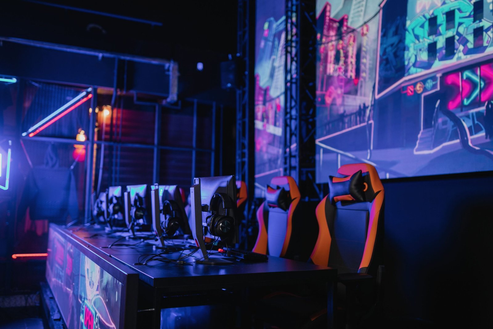 A professional technology journalism photograph capturing a futuristic esports arena illuminated with vibrant neon lights and massive stage displays representing Esports World Cup 2026 Paris tickets updates