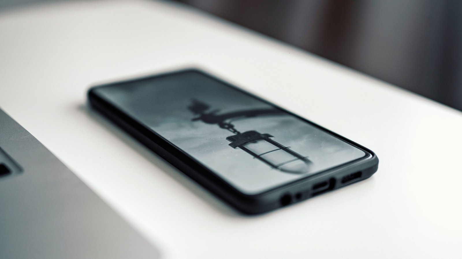 Modern Android smartphone resting on a desk with processor chip schematics overlaid in glowing digital display