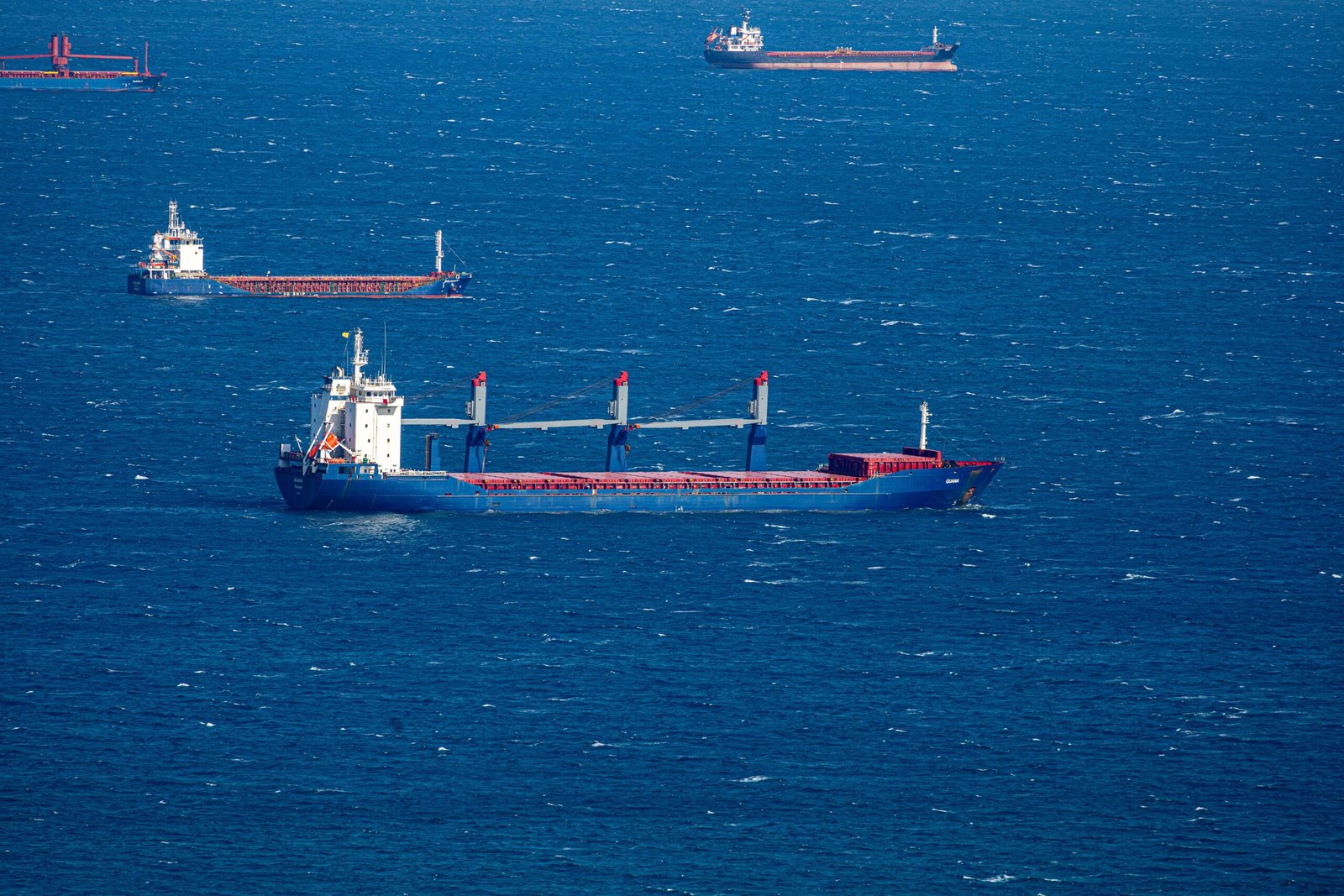 A professional maritime logistics photograph capturing a major global shipping tanker navigating open waters representing how hedge funds Brent oil maritime risk models operate