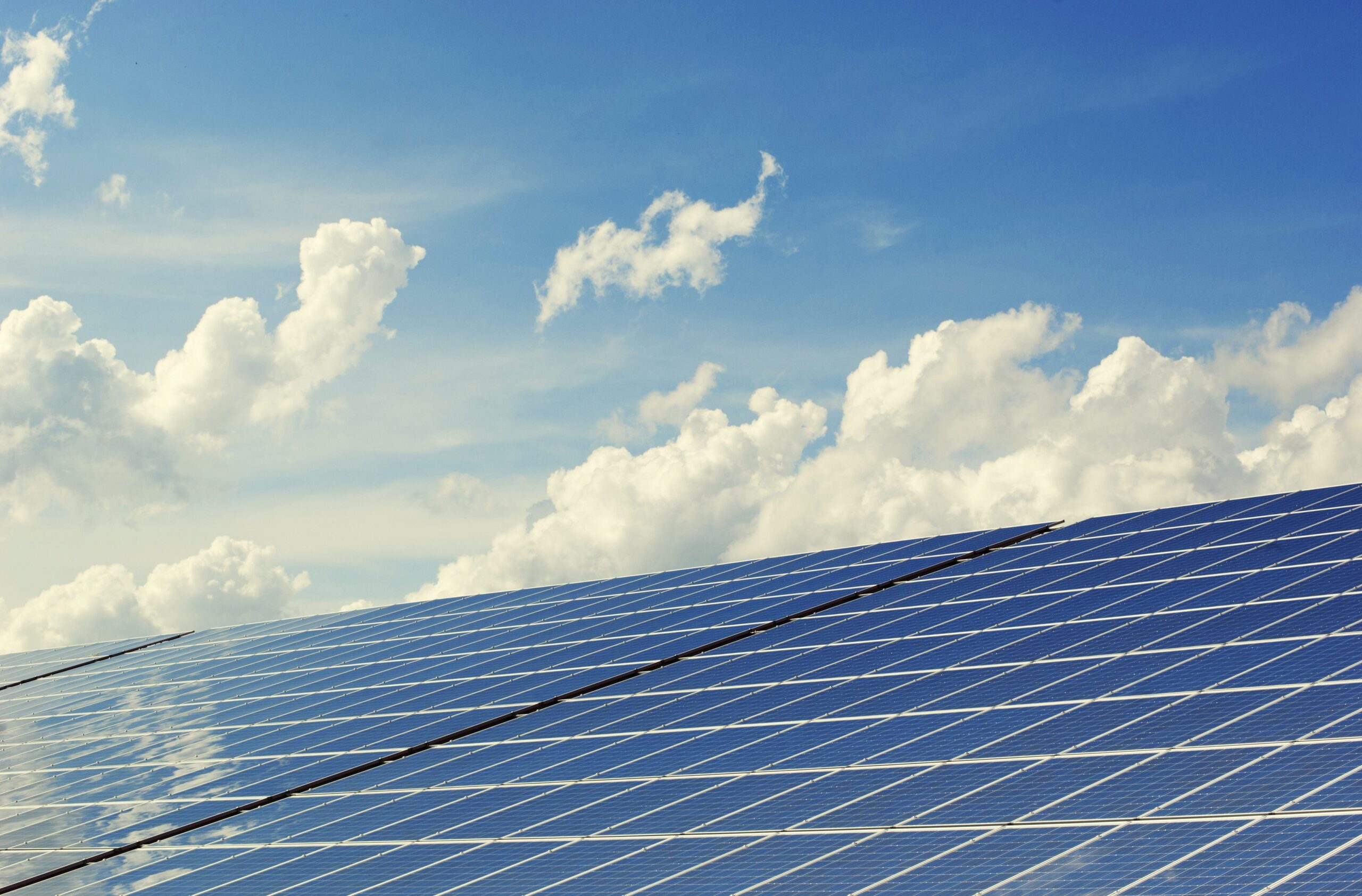 A professional technology journalism photograph showcasing a clean architectural glass window panel reflecting sunlight with conceptual green energy digital data overlays