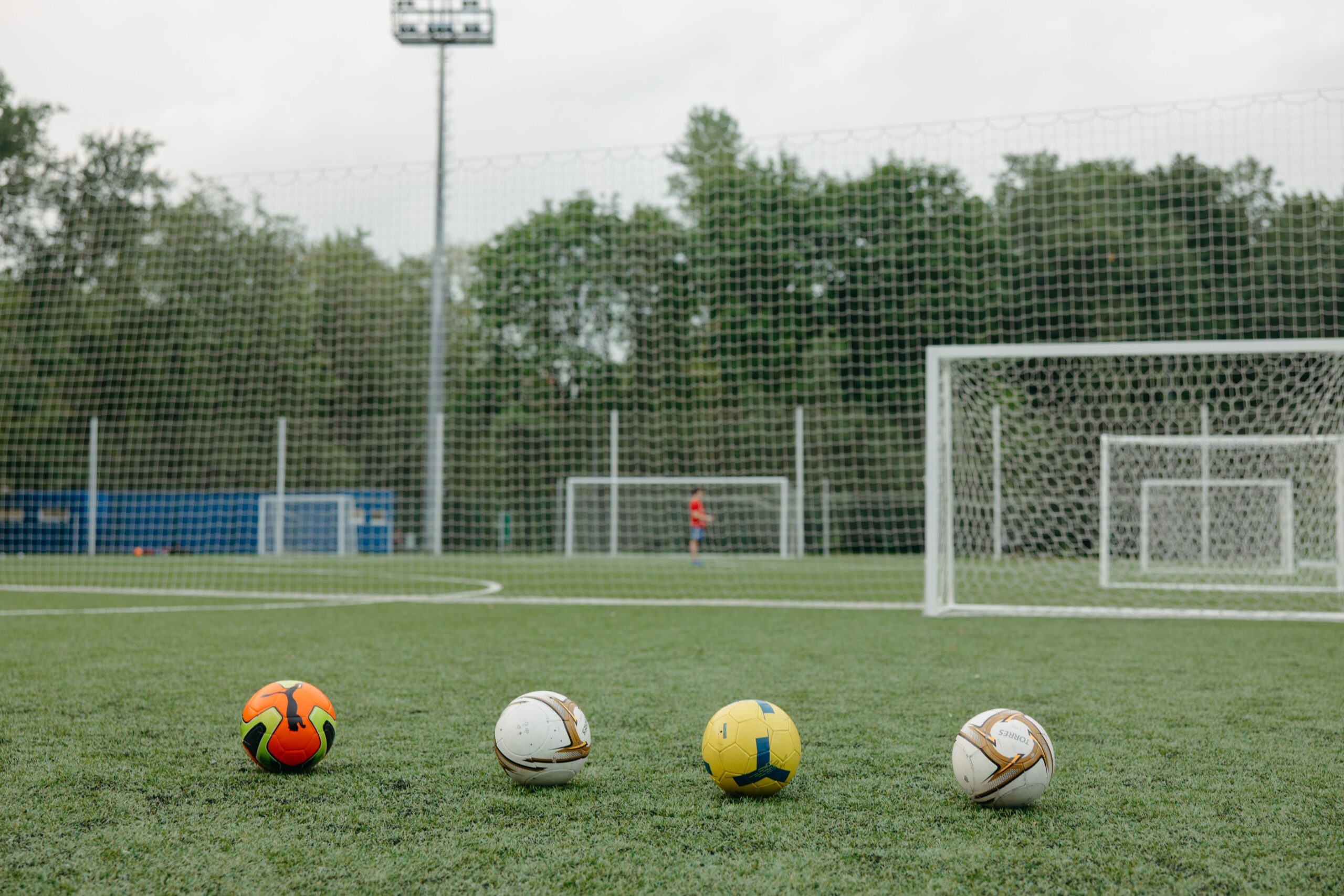 A professional football match leather ball resting on a crisp white net mesh background