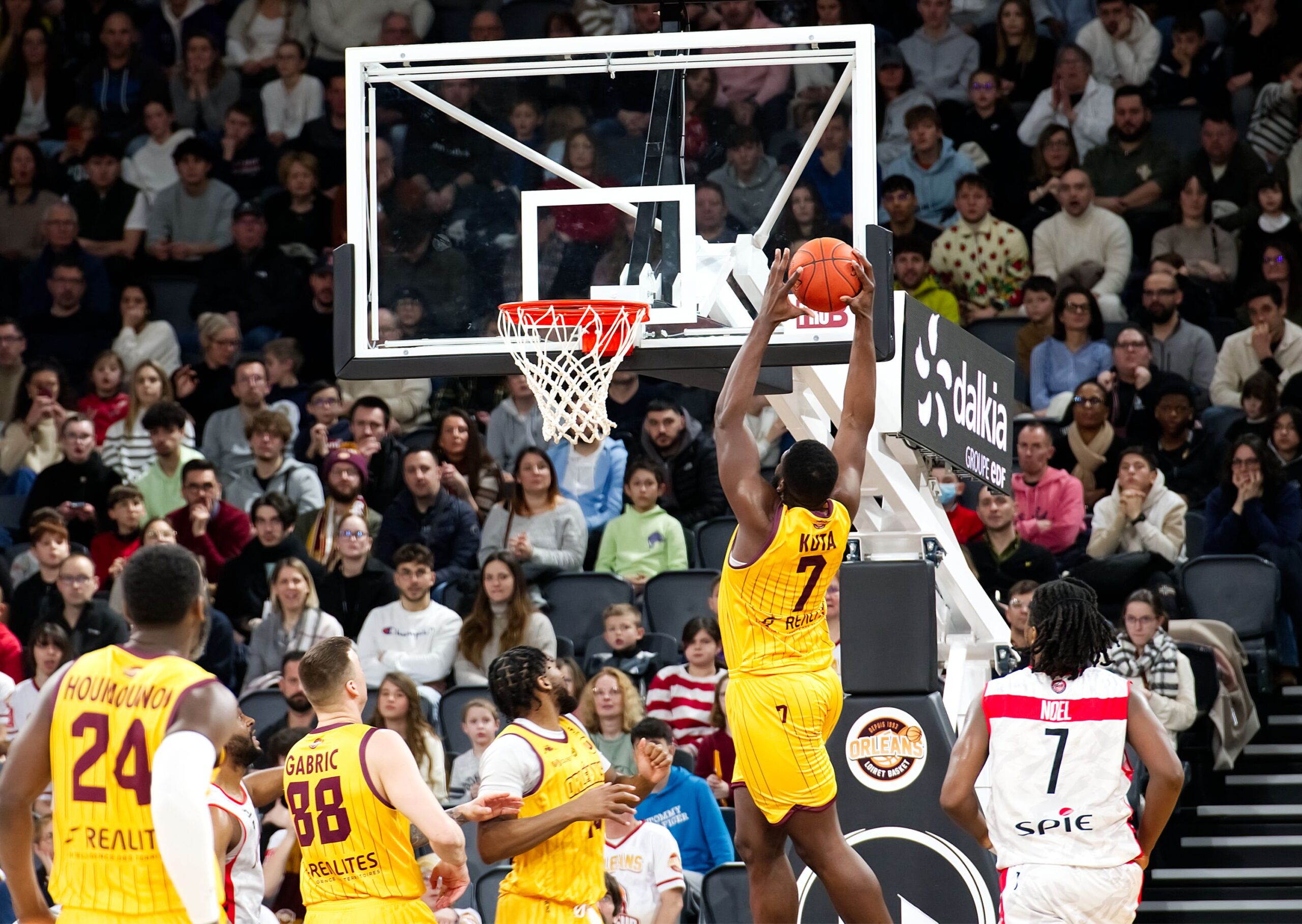 A professional polished hardwood indoor basketball court floor under bright overhead arena arena lighting grids