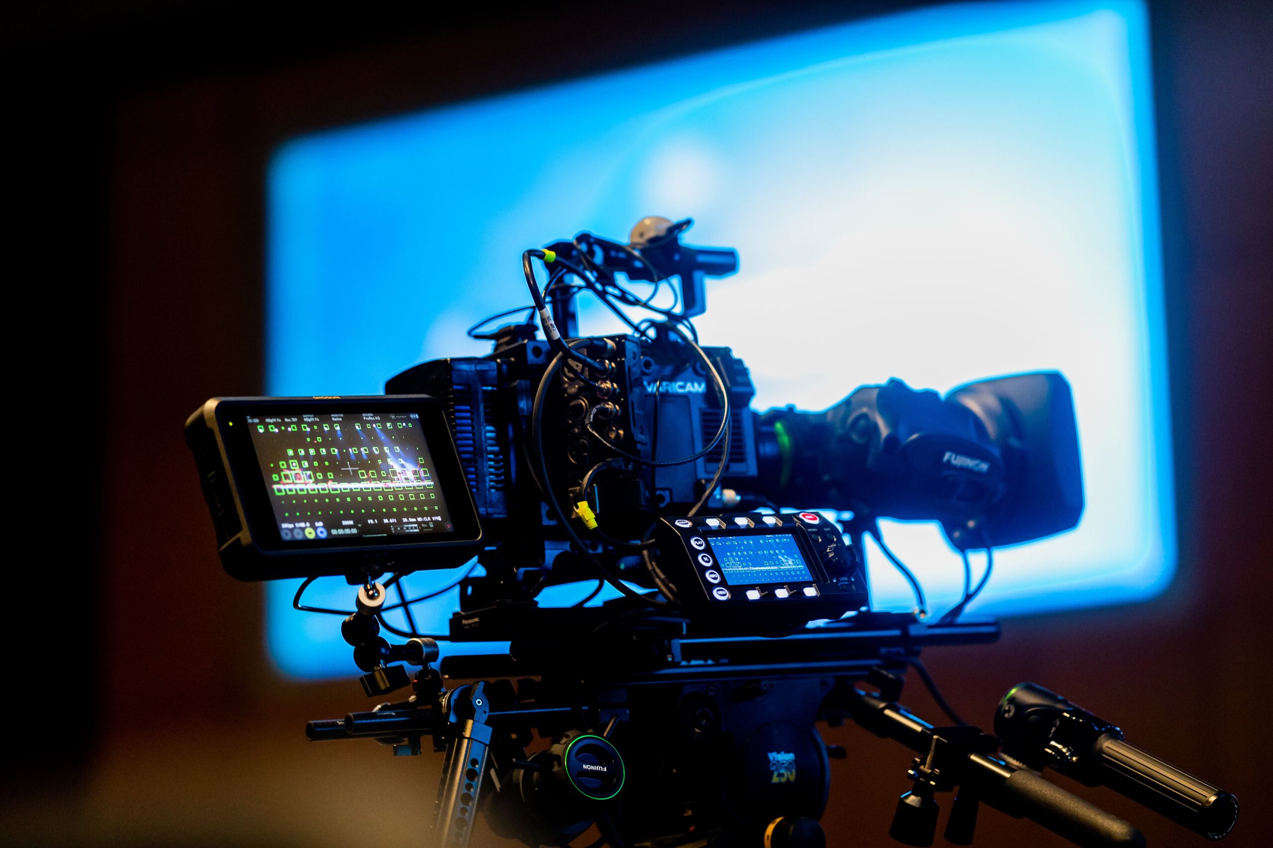 A professional modern television display showing crisp colorful cinematic media graphics inside a dimly lit living room