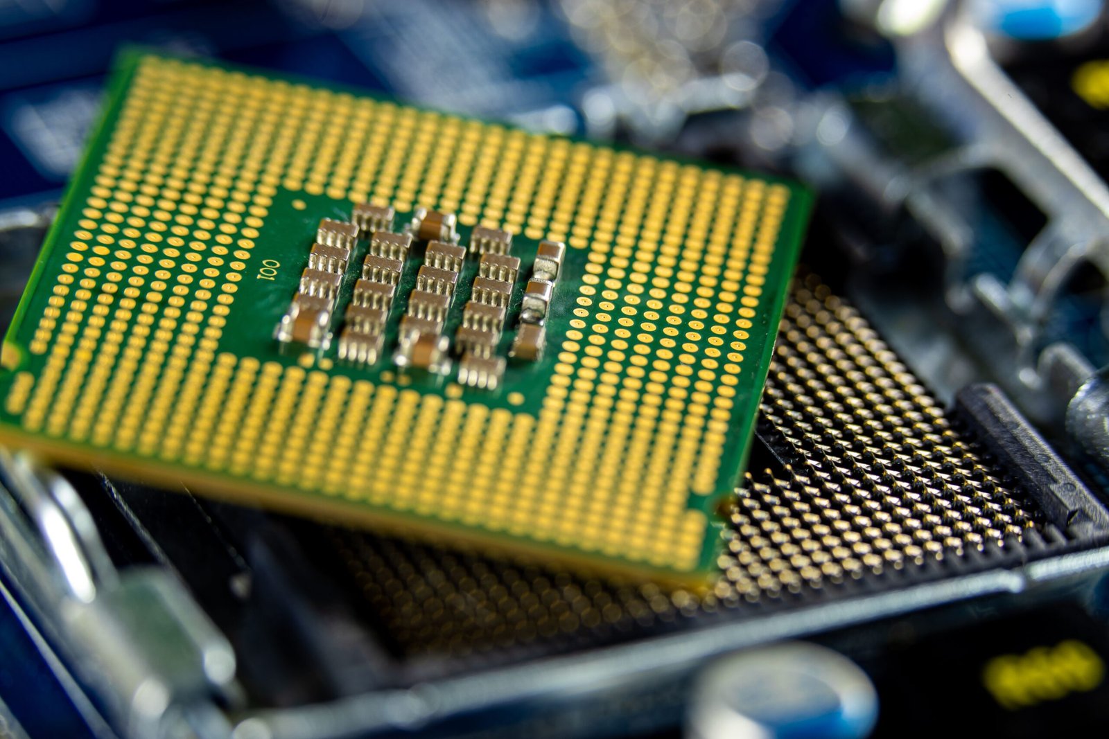 A crisp macroeconomic photograph of a premium golden semiconductor chip layout emphasizing complex electrical routing arrays.