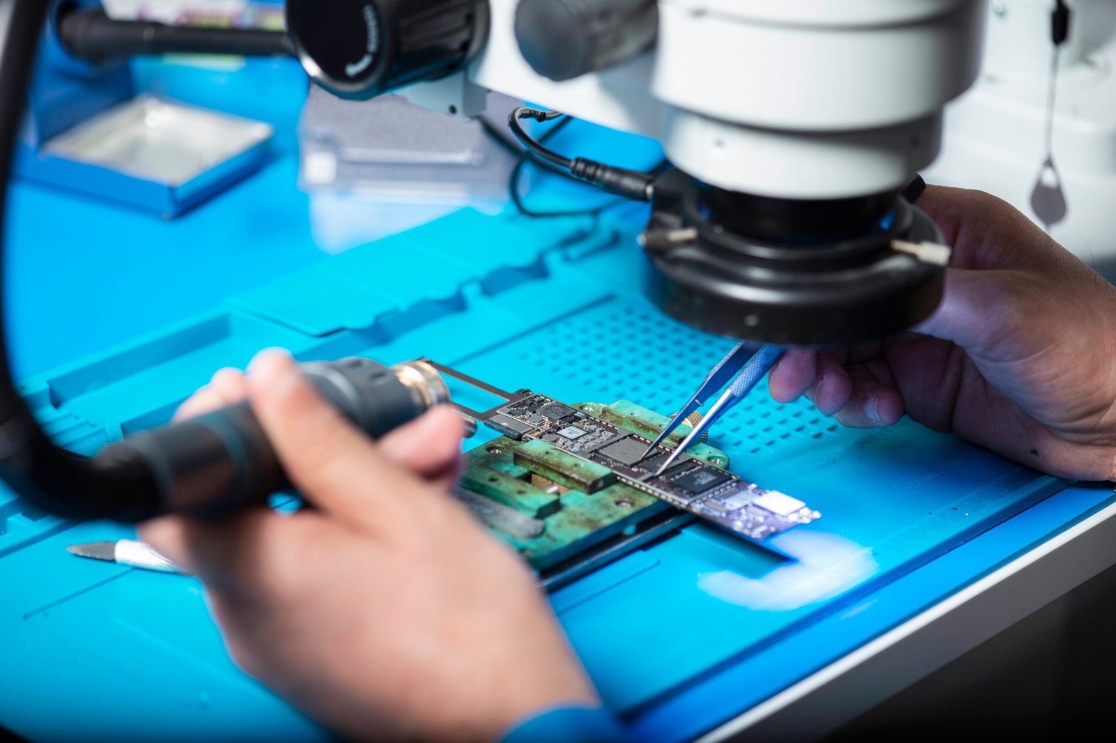 A professional micro-engineering photograph displaying precision assembly tools representing how the Pebble smartwatch screen replacement program executes