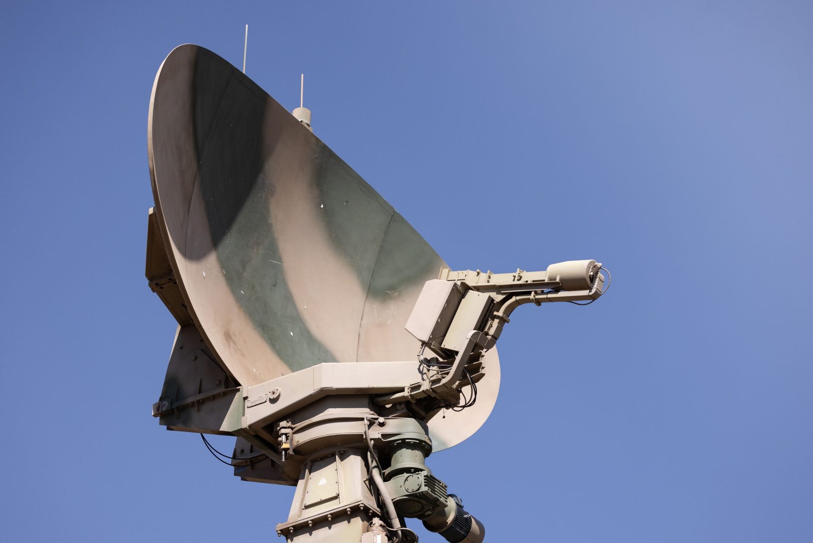A professional aerospace journalism photograph showcasing advanced military satellite communication electronics representing the Pentagon radiation hardened micro chip investment infrastructure