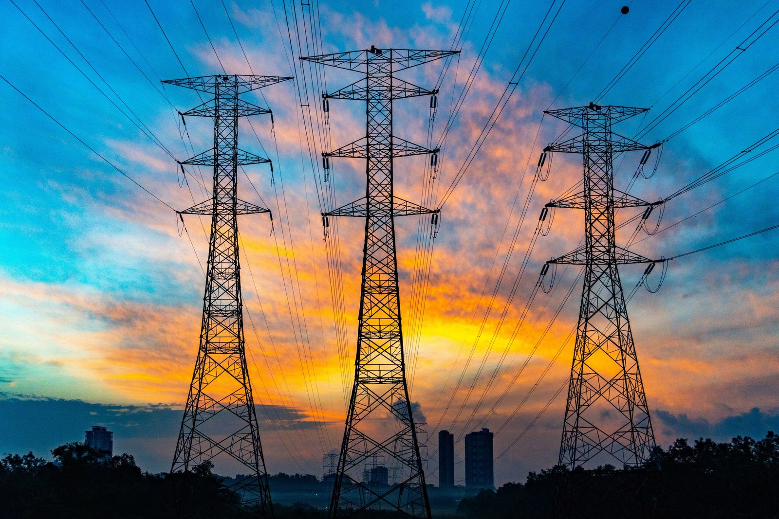 Aerial visual of a hyperscale AI data center facility adjacent to high-voltage power lines and water cooling infrastructure