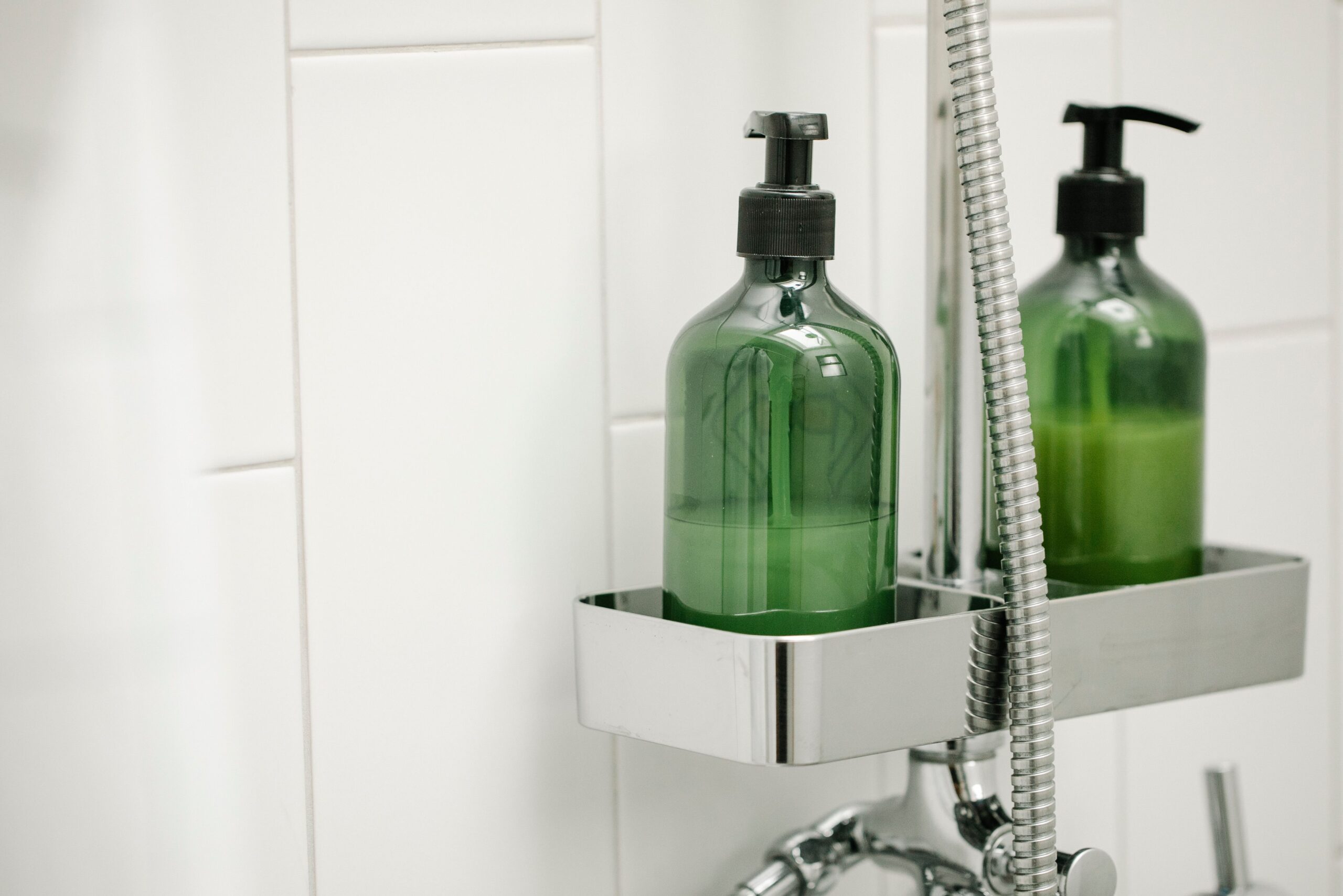 A crisp photograph showcasing retail shampoo bottles placed neatly inside a modern bathroom setting under bright lighting