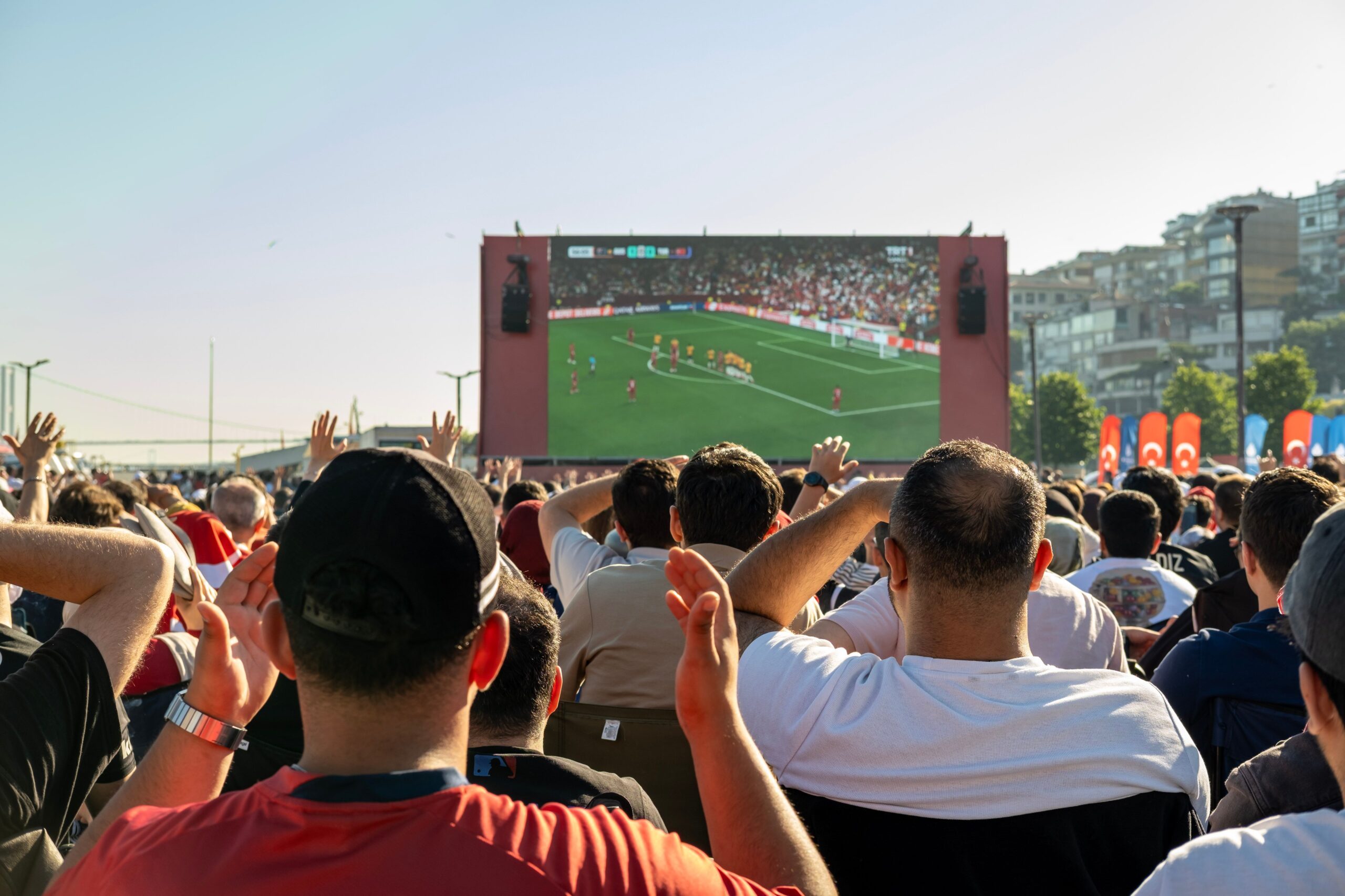 A professional stadium video review monitor showing the official purple VAR text design at a football match arena
