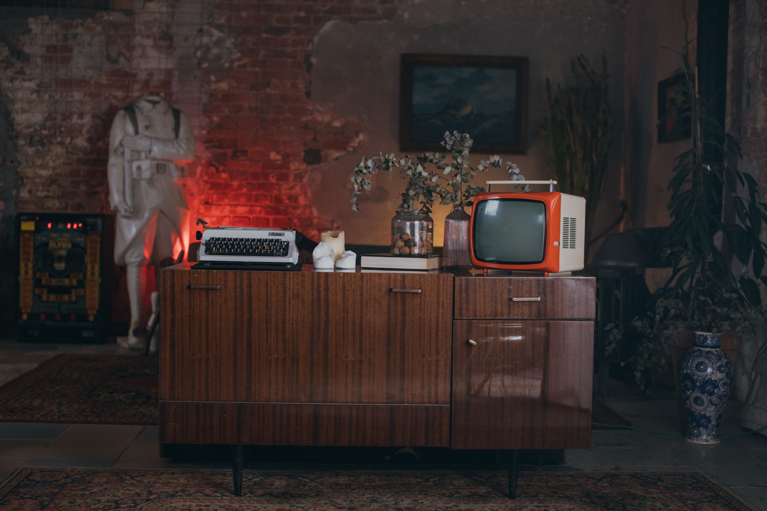 A professional media journalism photograph showcasing a classic retro broadcast environment with soft ambient lighting illuminating an entertainment production archive