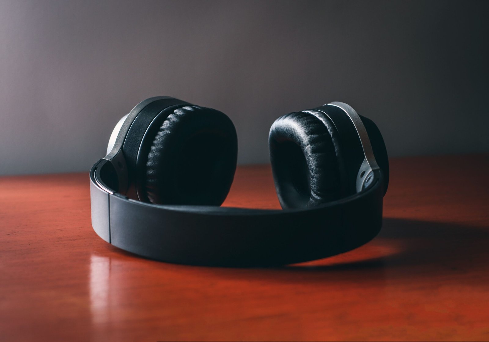 A professional acoustic journalism photograph capturing carbon-composite headphone bands representing how the Skullcandy Crusher 1080 flagship audio system functions