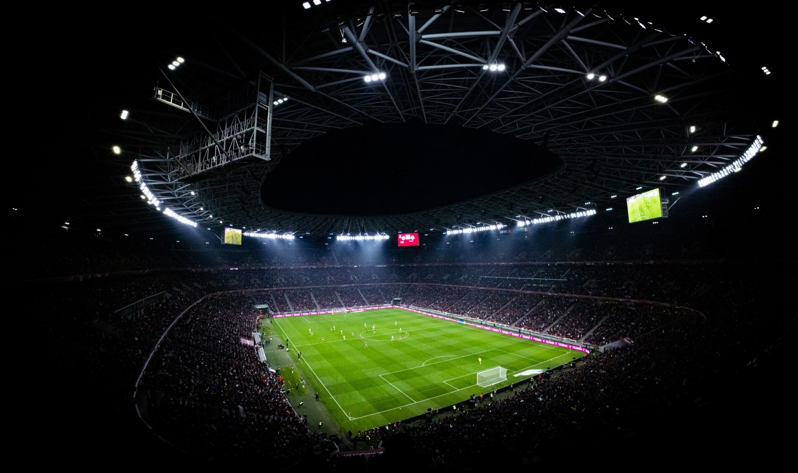 A crisp wide-angle cinematic shot capturing the illuminated sporting stadium where the 2026 tournament concludes.