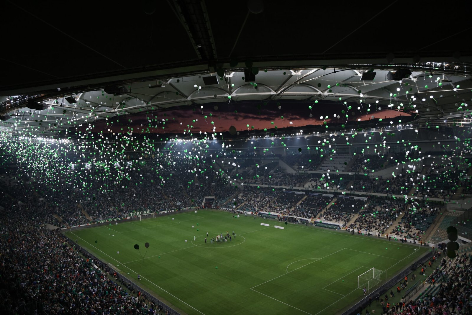 A high-end cinematic long shot capturing the bright stadium lights illuminating the grand sporting framework where Spain faces Argentina in the World Cup final.