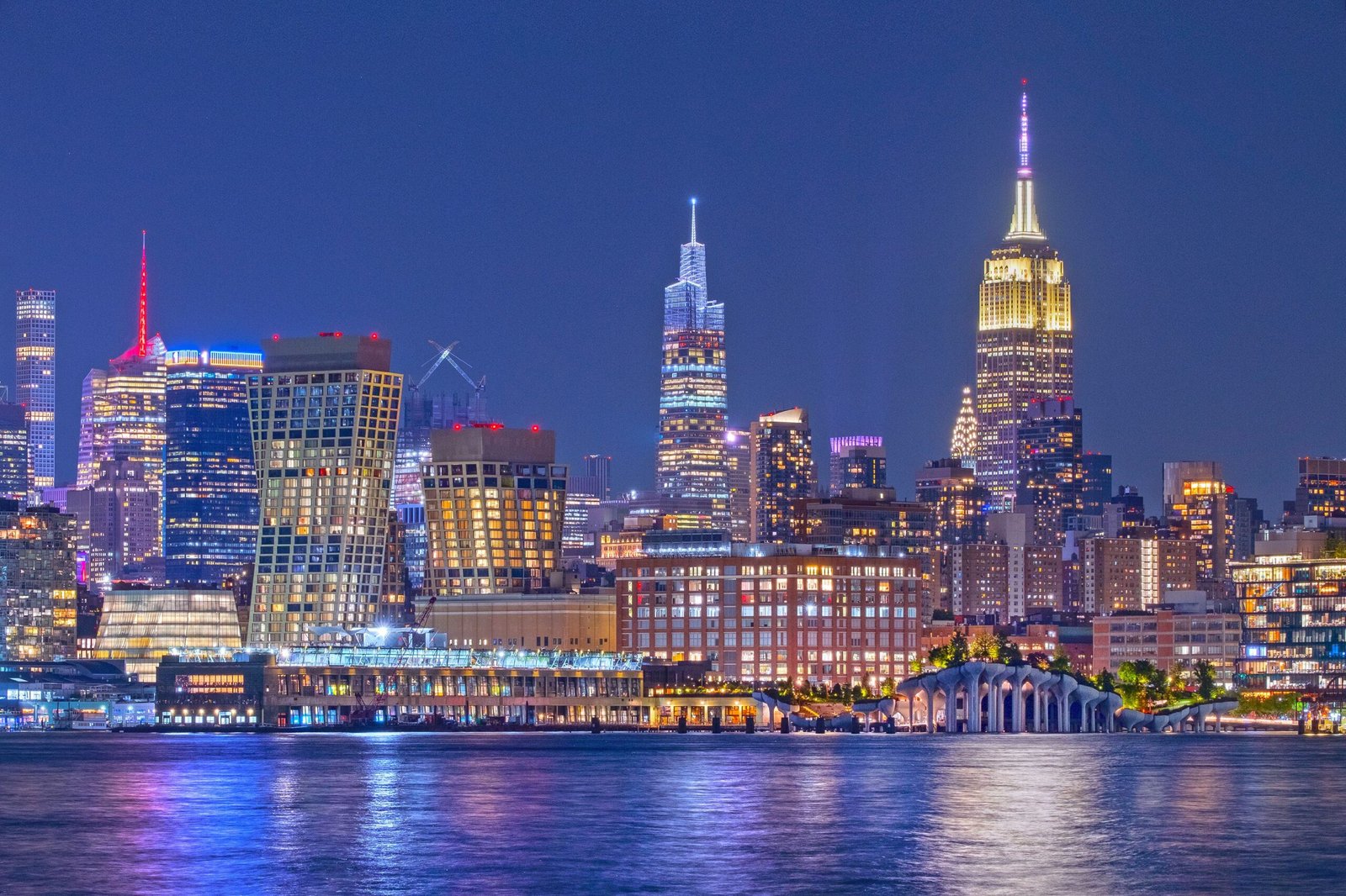 Cinematic view of New York City skyline at night with digital network overlays reflecting modern isolation themes