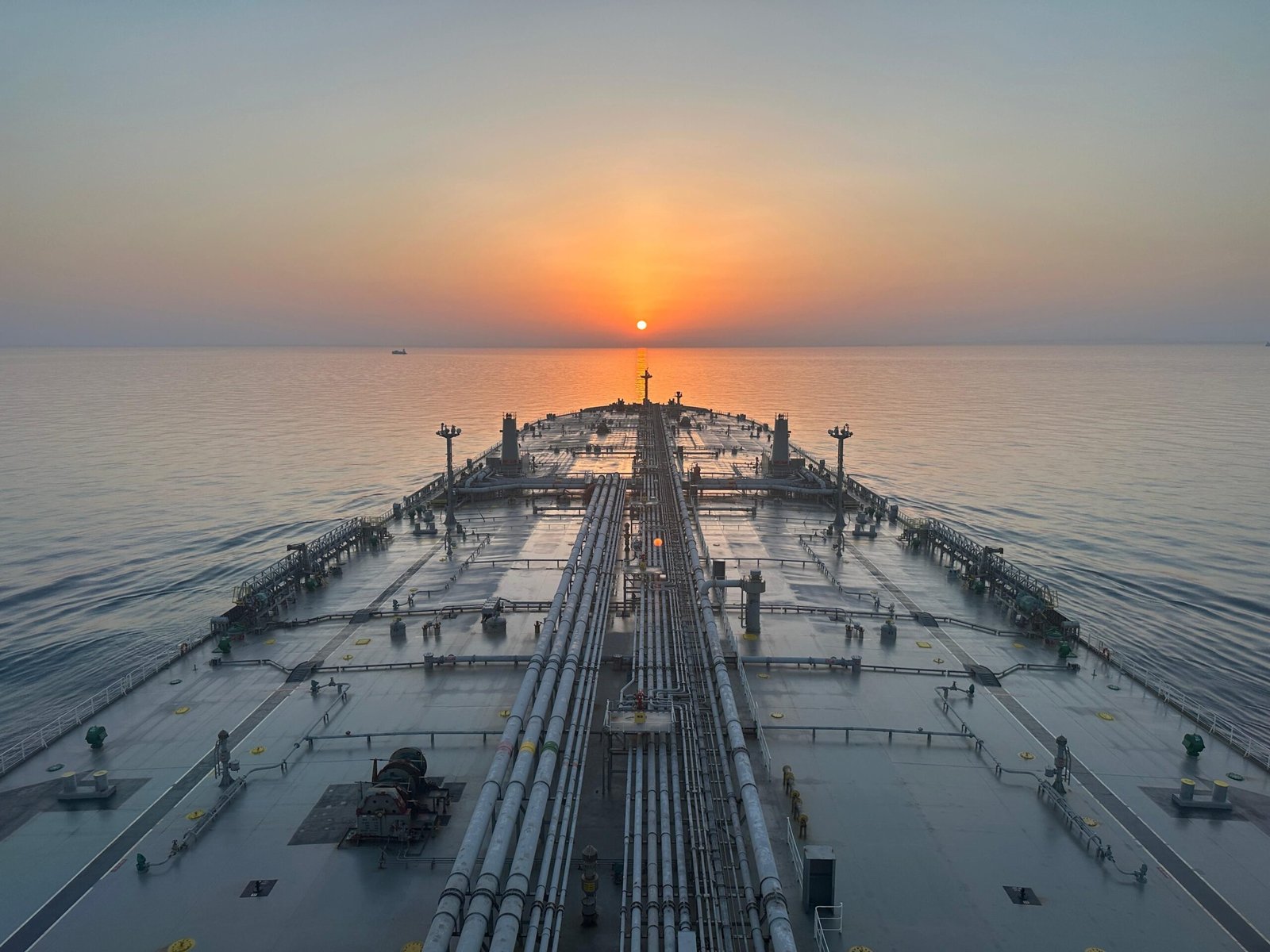 A wide-angle photograph of a large commercial oil tanker ship navigating ocean waters.