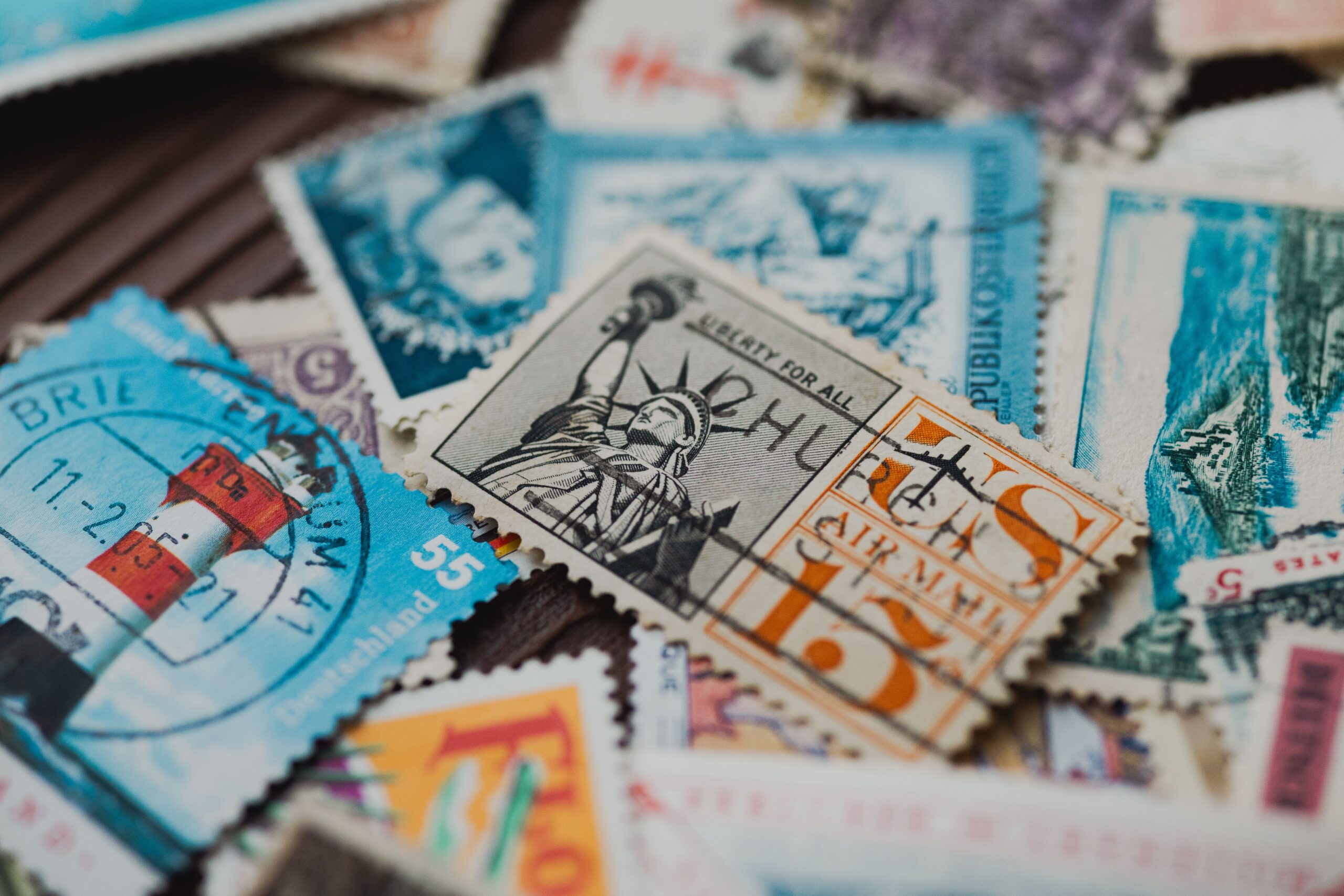 A professional commercial photograph displaying standard postal envelopes and official mailing stamps under organized office lighting