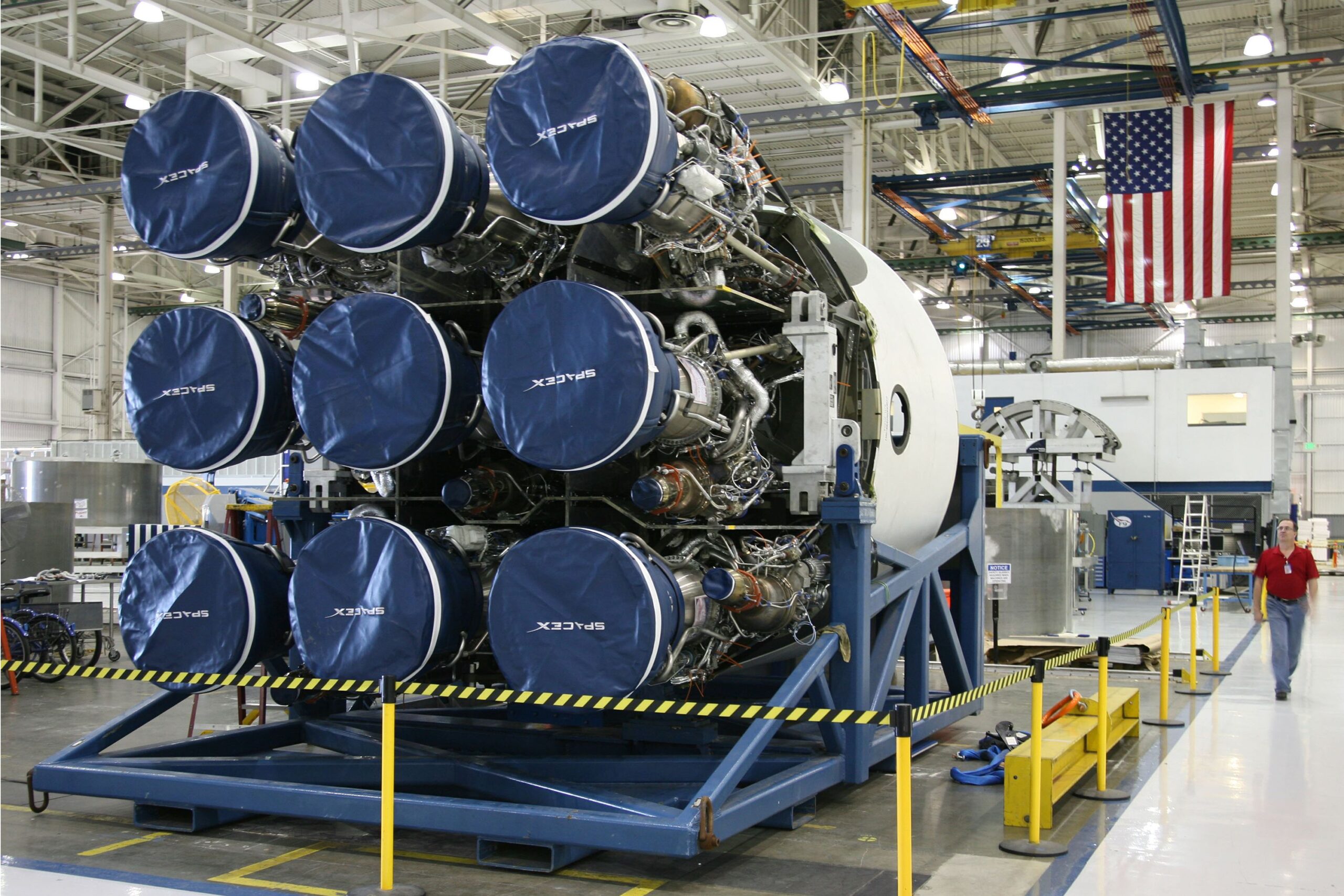 A professional aerospace journalism photograph displaying a sophisticated metallic propulsion architecture system setup inside a high-tech manufacturing laboratory