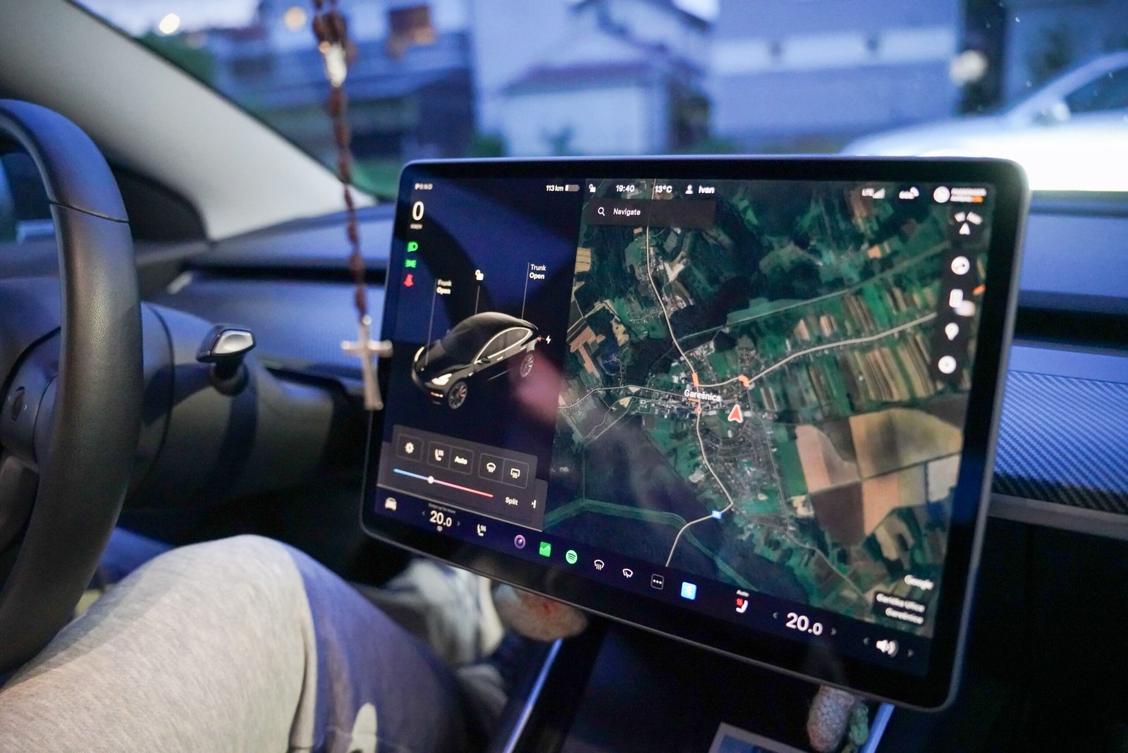 A professional automotive technology photograph capturing smartphone cables linking to dashboard screens representing wired Android Auto connection stability advantages