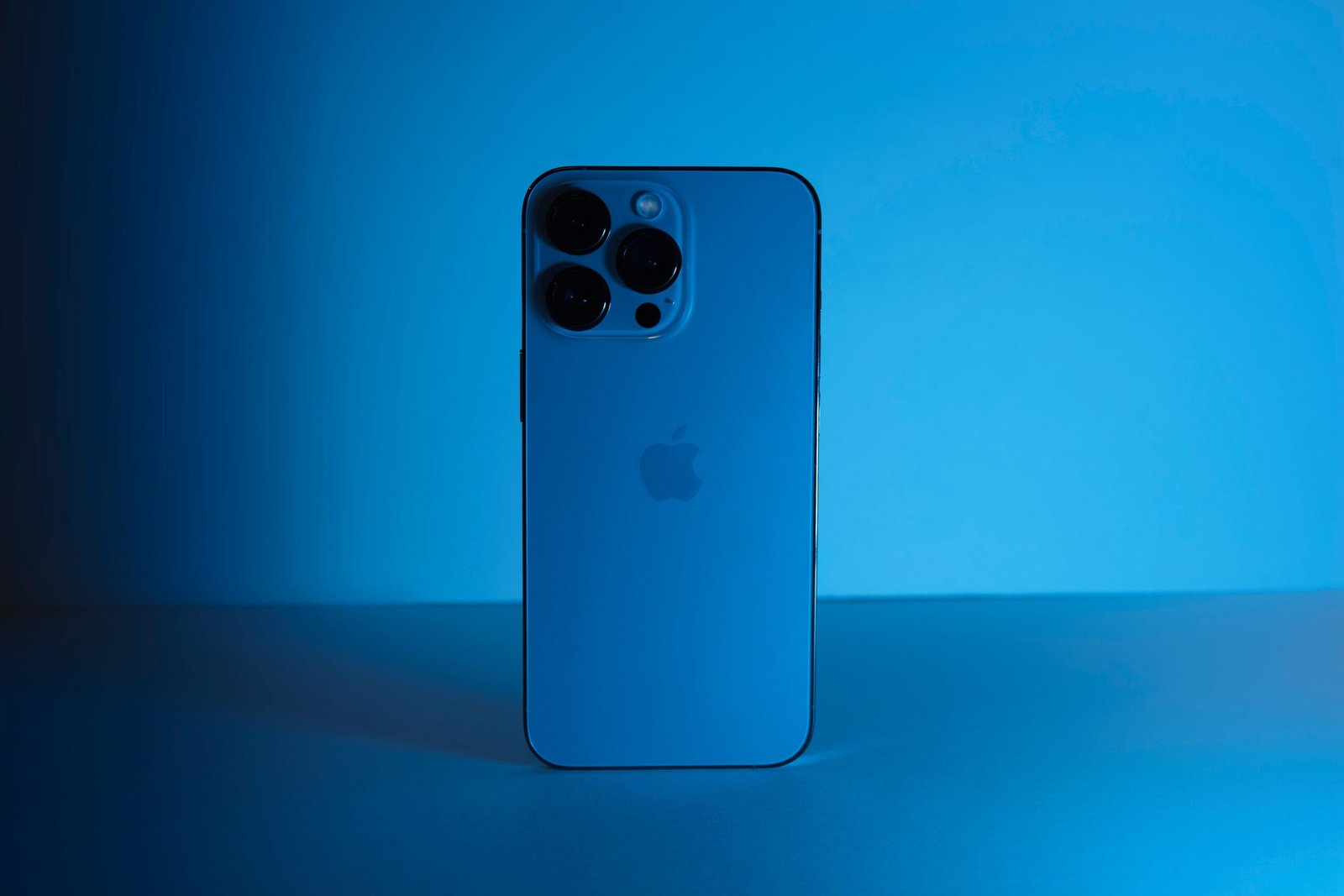 Futuristic concept of Apple 20th anniversary iPhone with a curved glass body and wraparound display