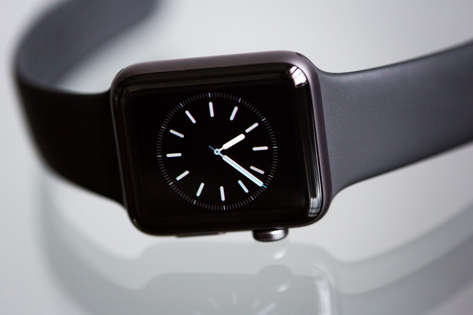 A sleek conceptual round Apple Watch with a circular OLED screen displaying watchOS interface