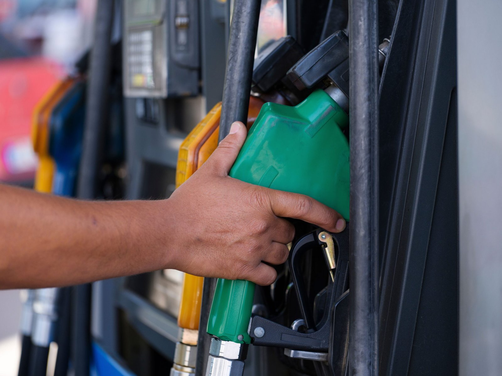 Fuel pump dispenser at a modern gas station showing E15 15 percent ethanol blend octane sticker