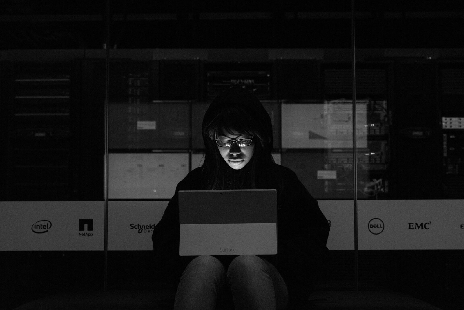 Digital cybersecurity shield glowing over cloud server rack architecture and encrypted data network lines